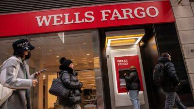 Wells Fargo profit falls as bank boosts loan loss reserves; shares rise