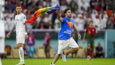 Rainbow flag protestor invades pitch at World Cup