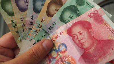 China's central bank steps in to slow its rapidly weakening currency, as yuan hits one-year lows