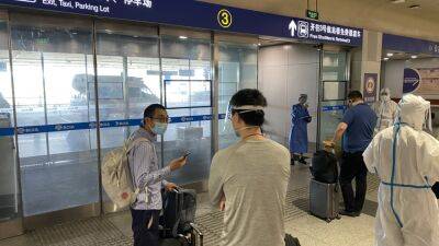 China cuts quarantine time for international travelers in big step toward easing Covid controls