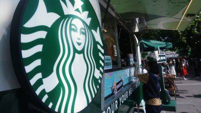 Stocks making the biggest moves midday: Starbucks, CarMax, Virgin Galactic and more