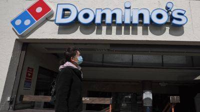 Stocks making the biggest moves midday: Domino's Pizza, DraftKings, Lucid, SunPower and more