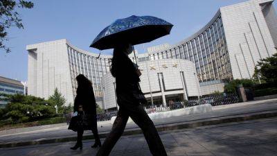 China's financial regulators urge support for resolving local debt risks