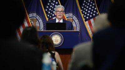 Fed holds rates steady and notes progress on inflation